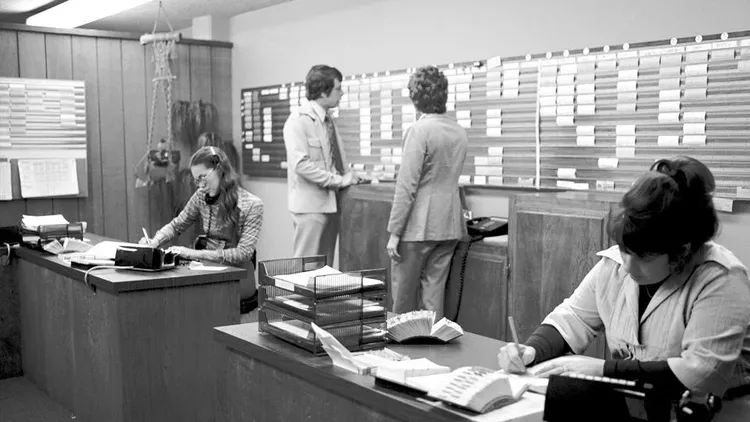 Black and white image of people in an office